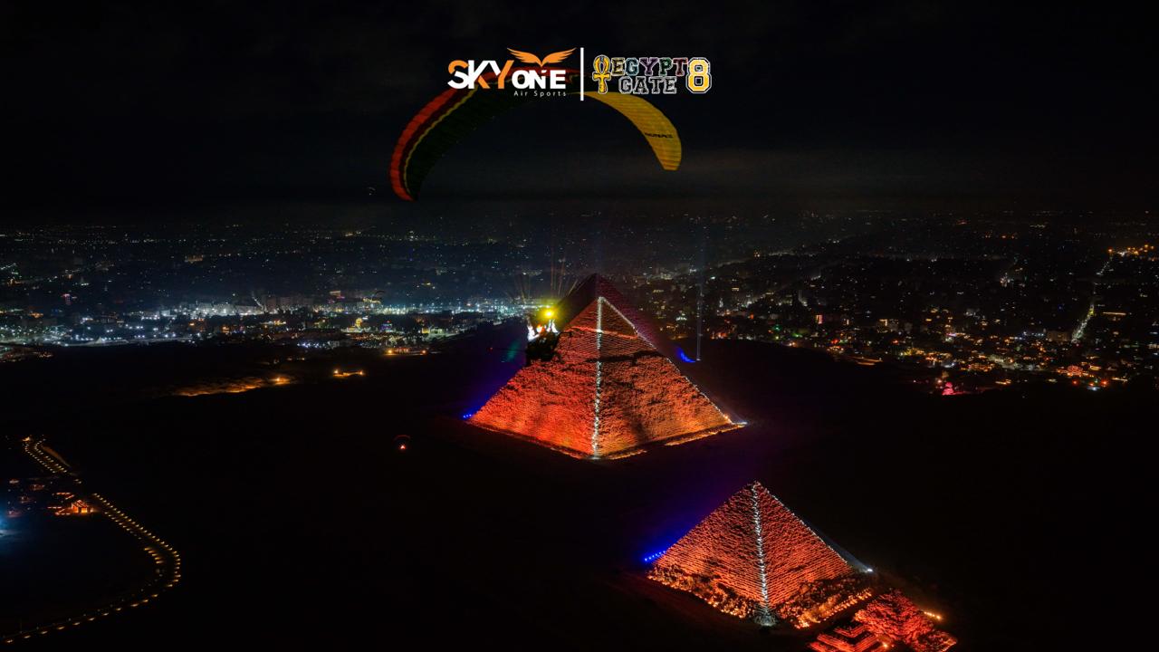 Night flying over illuminated pyramids